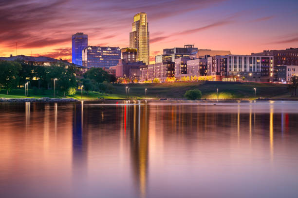 Cityscape image of downtown Omaha, Nebraska with reflection of the skyline at beautiful autumn sunset.